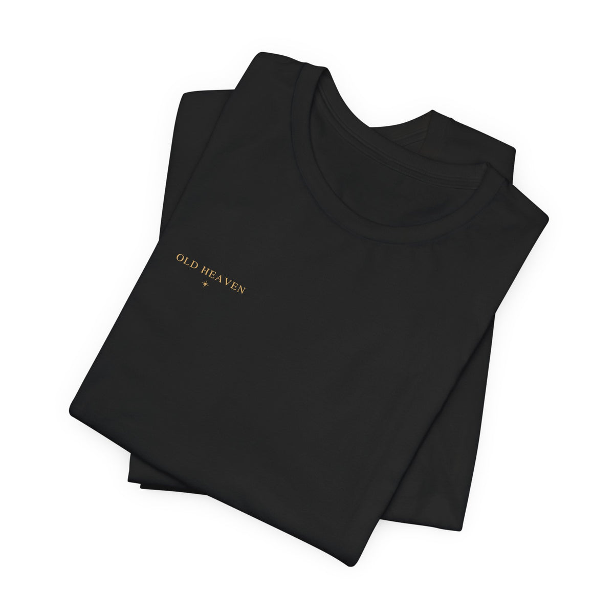 Folded black Old Heaven Cobalt Defiance T-shirt showing the small antique-gold wordmark and eight-point star.