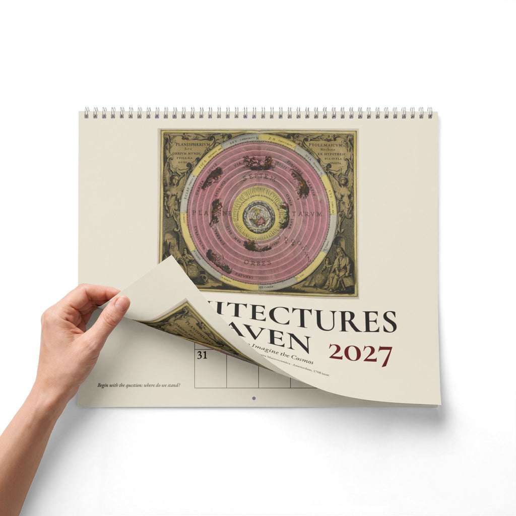 Mockup: a hand lifting the front cover of the 2027 Cellarius wall calendar to show the pages beneath