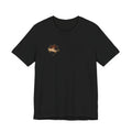 Front of black Old Heaven No. 001 T-shirt with a small auburn classical portrait and gold stars on the wearer's right chest.