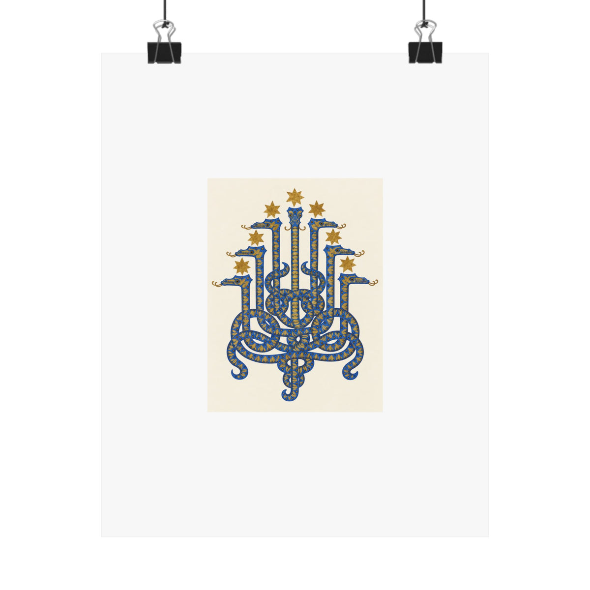 Herodias serpent art print held by two black clips: seven cobalt heads and ochre stars on ivory with a wide white border.