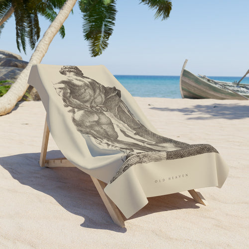 Hercules at Rest art towel draped over a wooden beach chair on the sand, the etched figure in tobacco on warm bone.